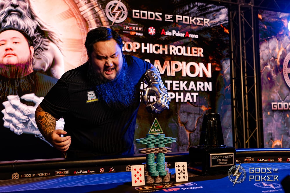 Excited bearded man with tattoos celebrating poker tournament win with trophy and chips.