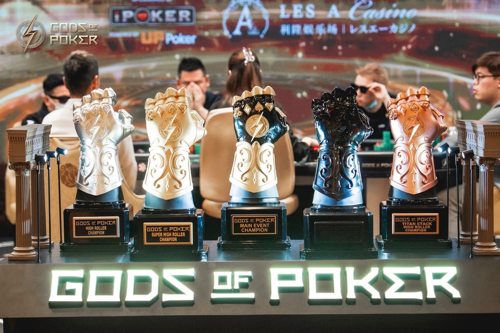 Five ornate gauntlet trophies for the Gods of Poker championship are displayed.